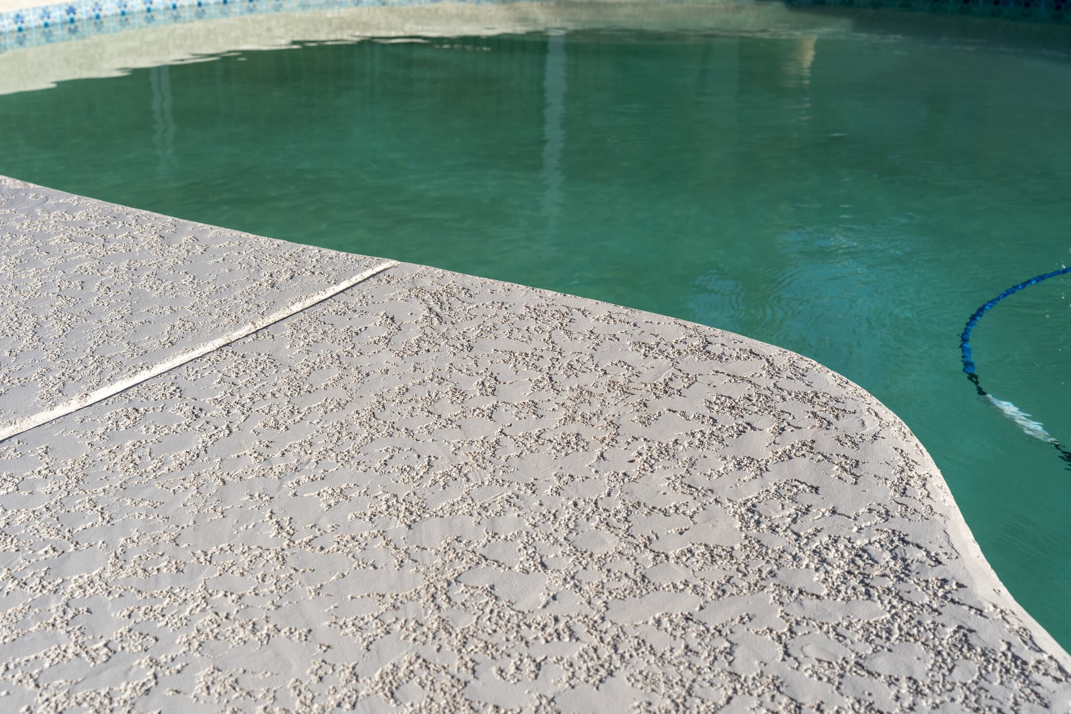 Resurfaced pool deck knockdown texture detail