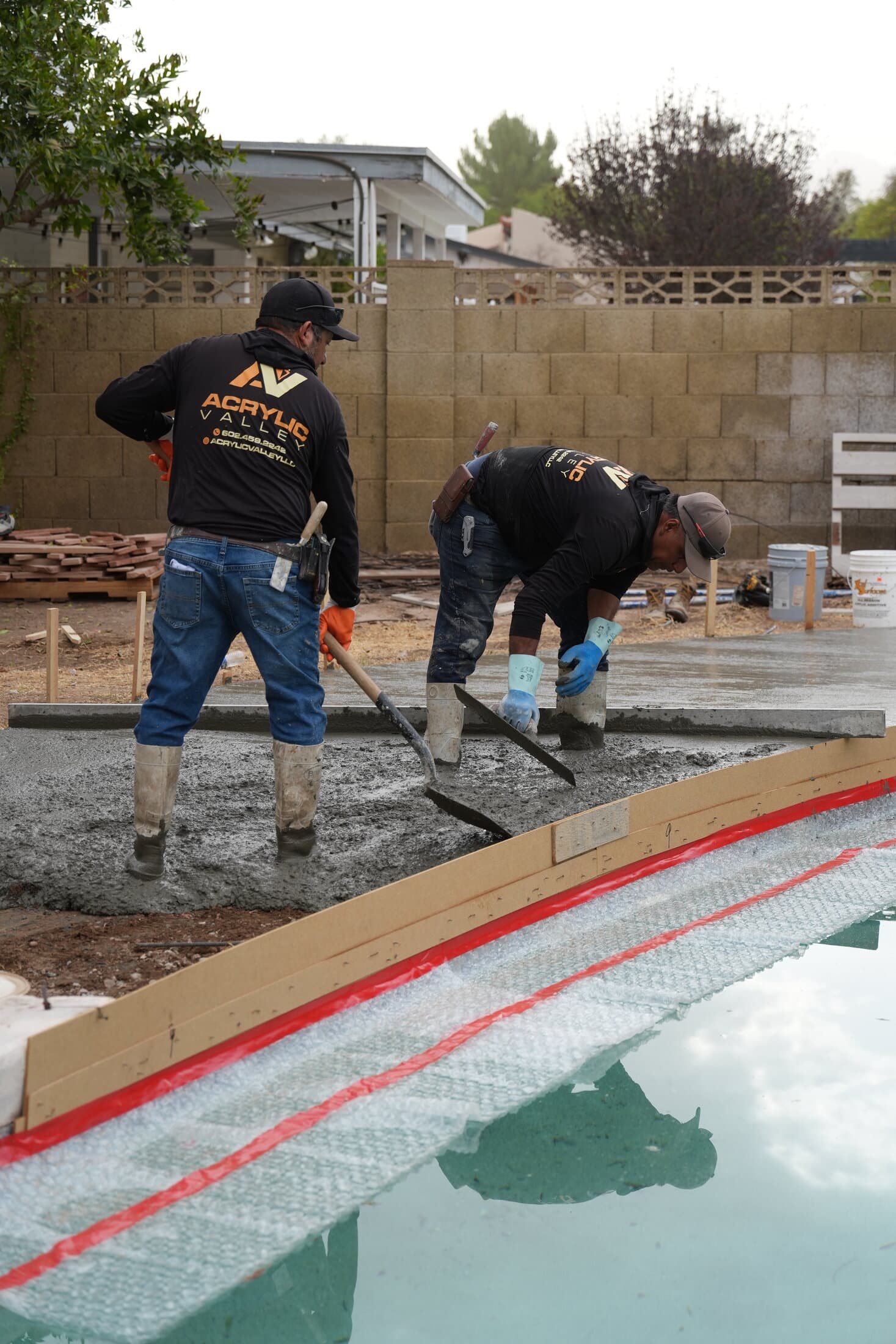 Acrylic Valley crew pouring concrete poolside