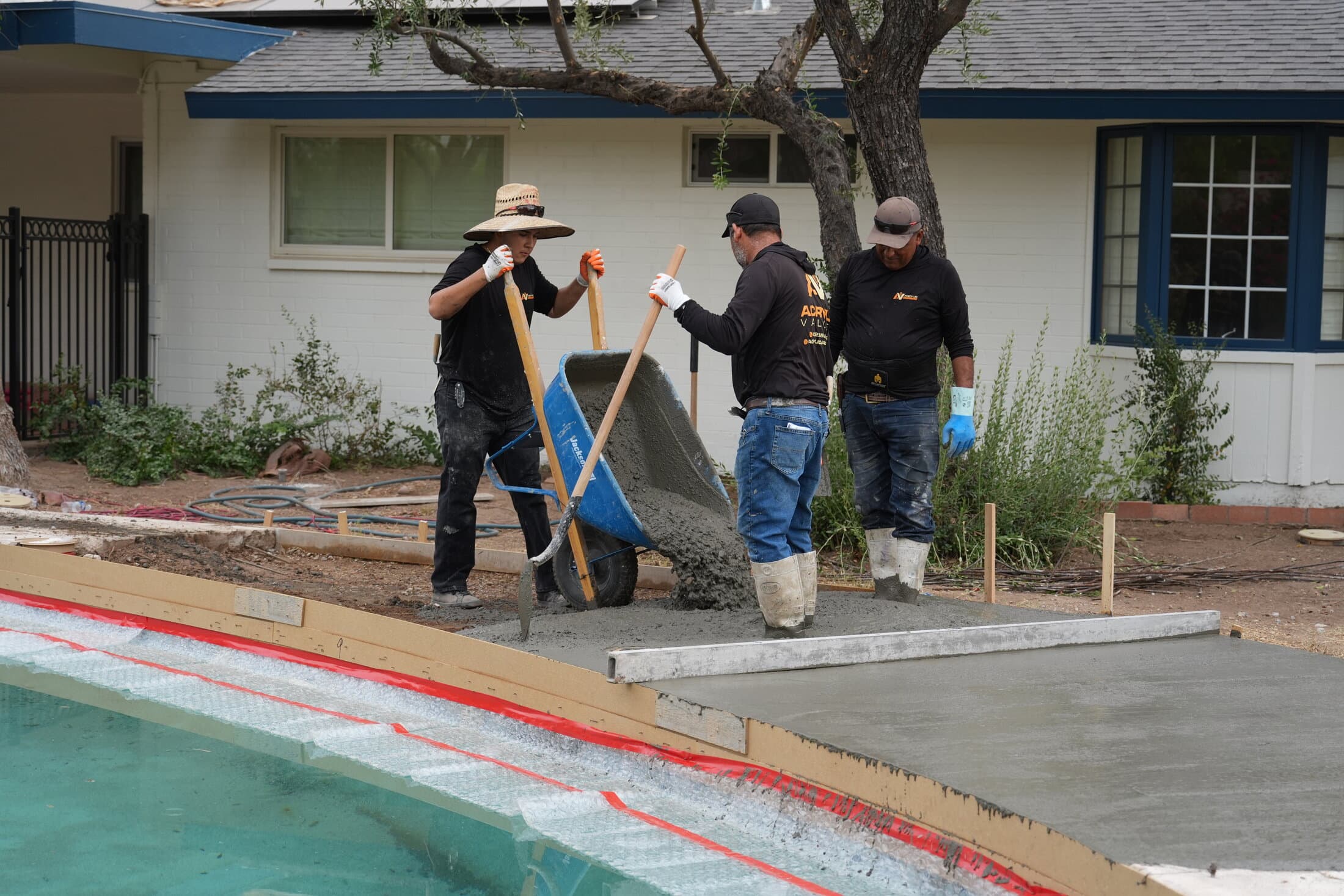 Acrylic Valley crew pouring and finishing concrete poolside