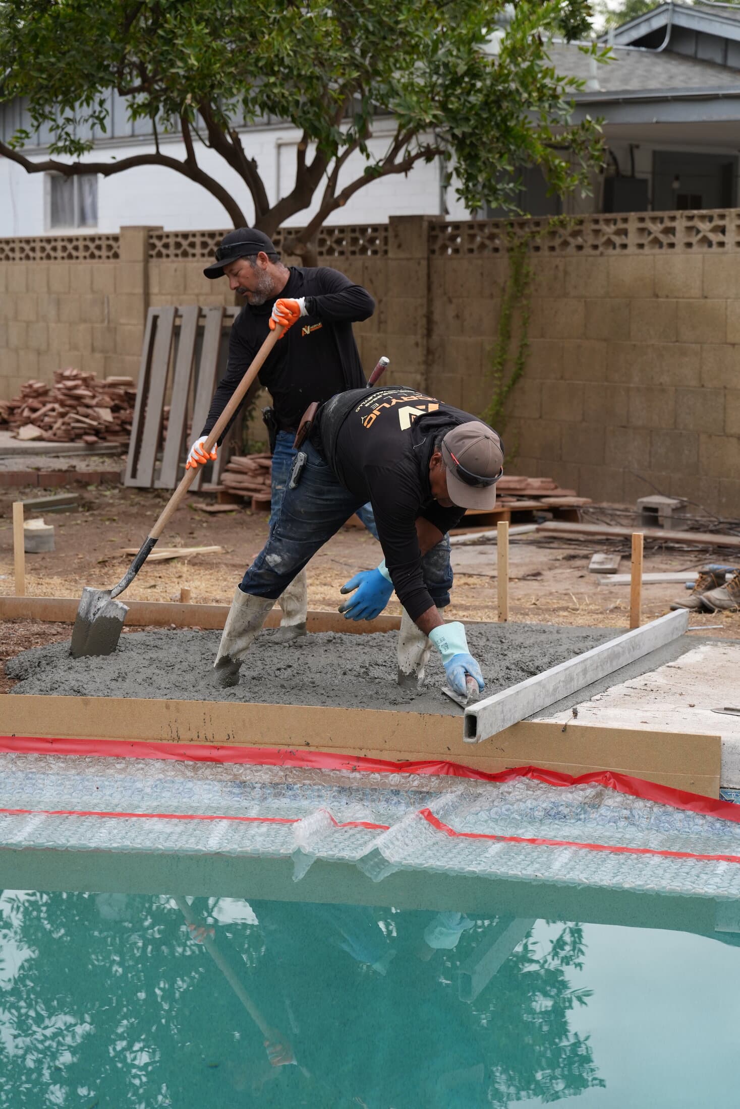 Acrylic Valley crew finishing a concrete pool deck edge